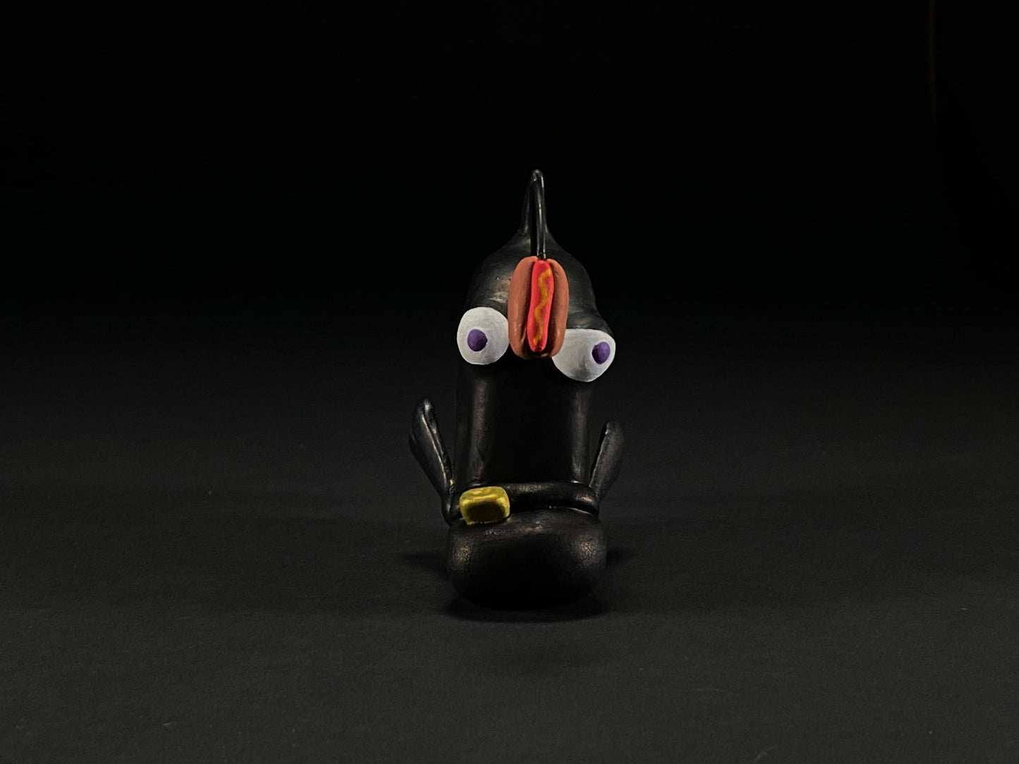 Head on shot of Randy-Ricky Randall toy with hot dog right between his eyes.