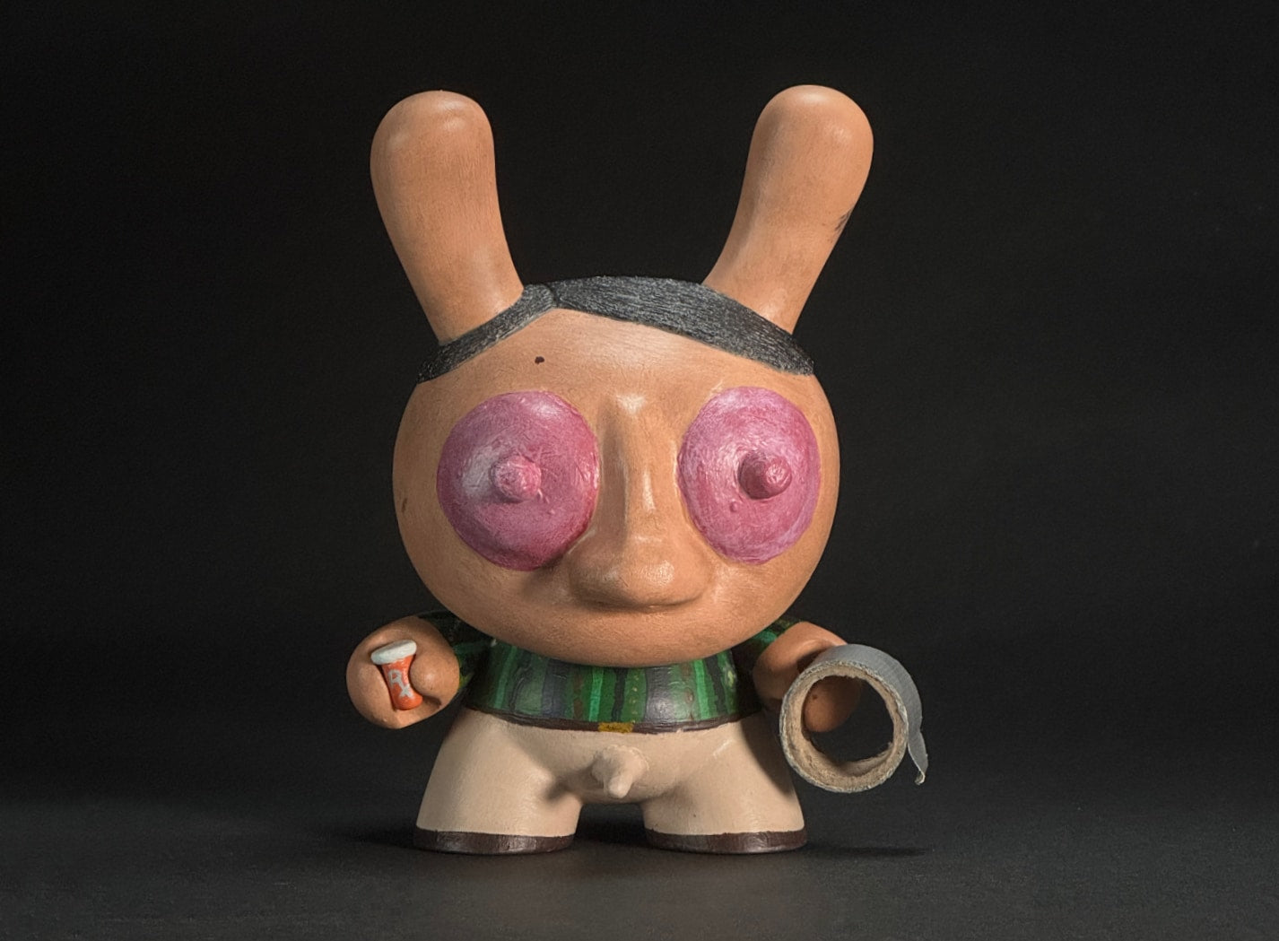 The Drugger - Holding an RX bottle in one hand and a roll of duct tape in the other. He looks grimy and dirty.