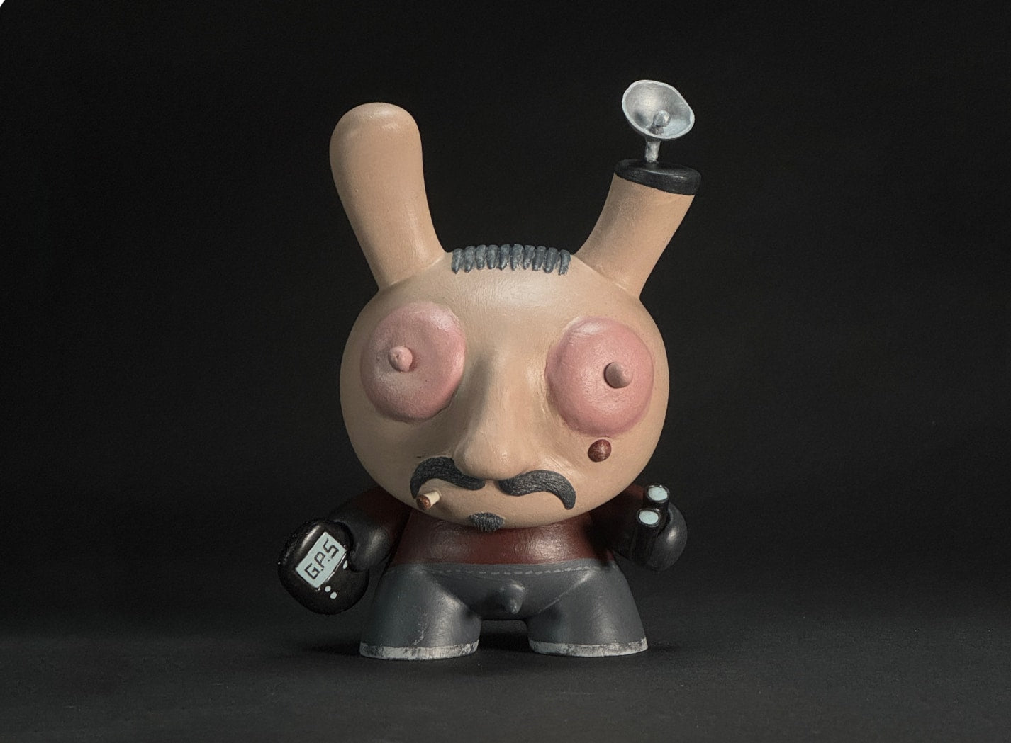 The Plugger - Has his GPS tracker in one hand and binoculars in the other. He has a tracking satellite on his head. He looks grimy and dirty.