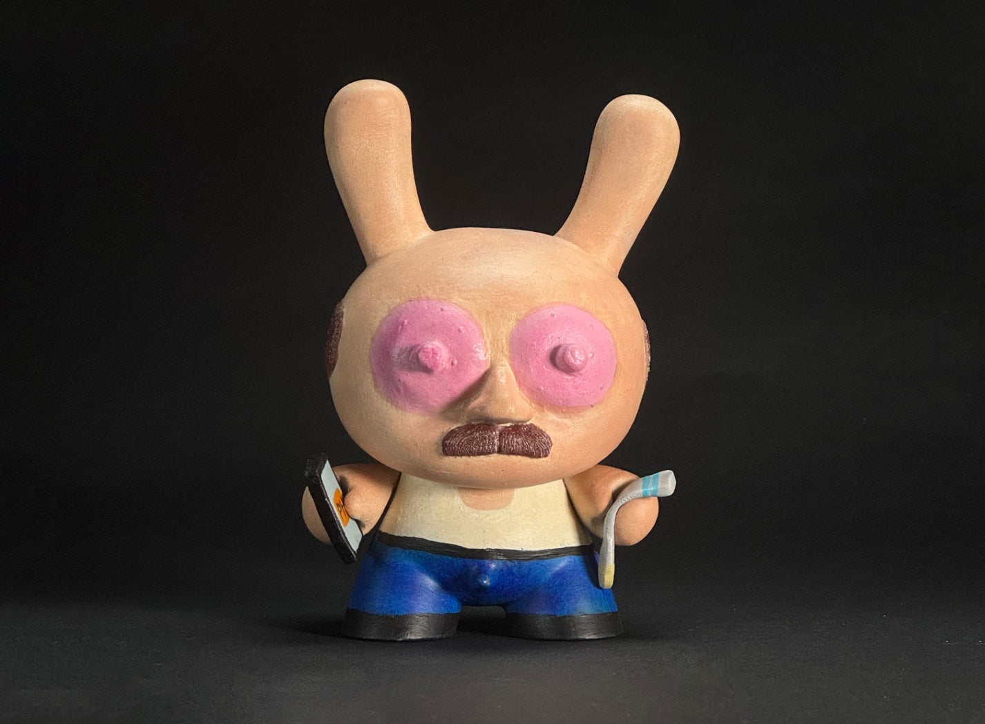 The Tugger - Holding a mobile phone with PornHub in one hand and a crusty c*m sock in the other hand. He looks grimy and dirty.